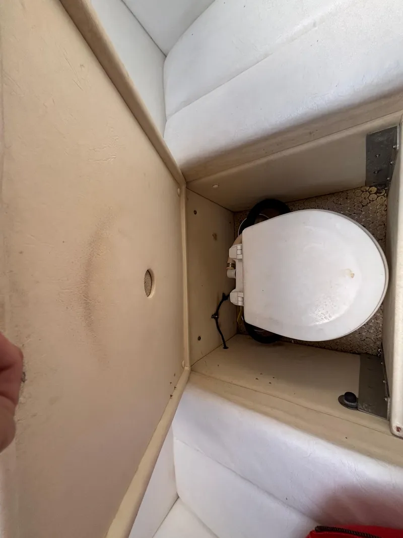 Slide: The Image of 1994 Apache 47 Fire Water boat interior with compact toilet setup. - 24