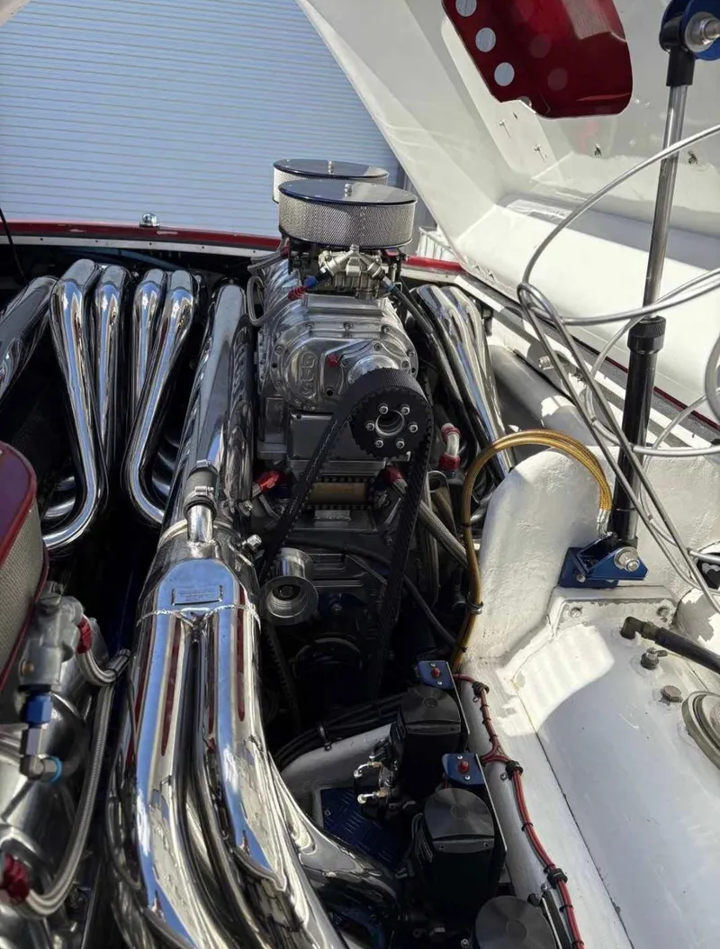 Slide: The Image of Engine of a 1994 Apache 47 Fire Water boat with chrome components and detailed mechanics. - 6