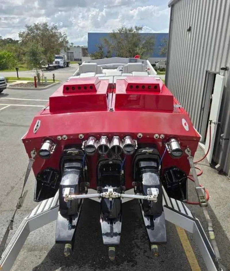 Slide: The Image of 1994 Apache 47 Fire Water boat with powerful engines, parked outdoors. - 7