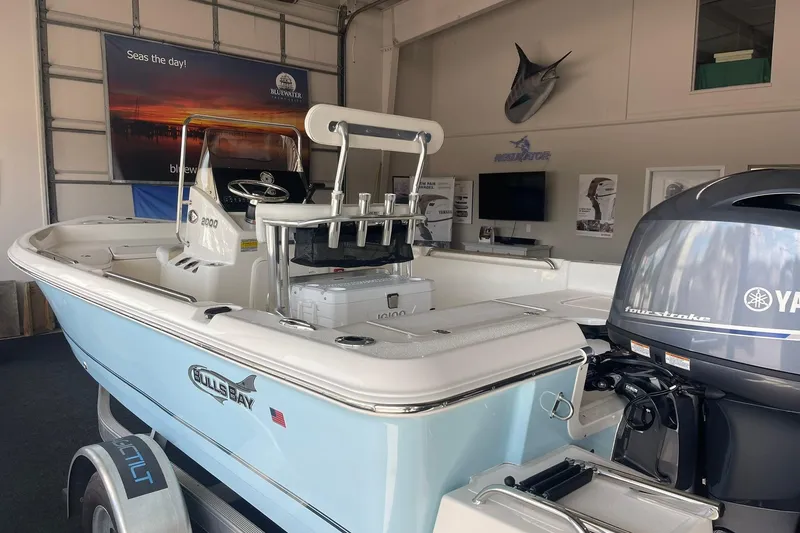 Slide: The Image of 2025 Bulls Bay 2000 boat with Yamaha engine displayed in showroom. - 5
