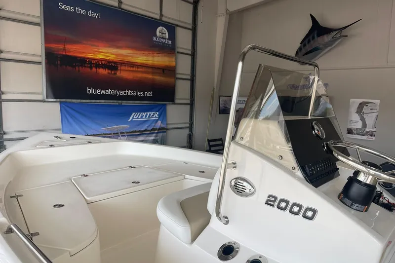 Slide: The Image of 2025 Bulls Bay 2000 boat interior in showroom with promotional banners. - 6