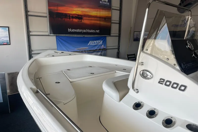 Slide: The Image of 2025 Bulls Bay 2000 boat interior in showroom with sleek design and modern features. - 7