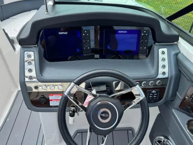 Slide: The Image of Helm of 2021 Chaparral 267 SSX OB with dual Simrad displays and modern controls. - 10