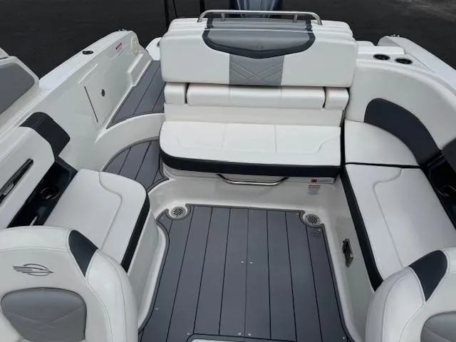 Slide: The Image of 2021 Chaparral 267 SSX OB boat interior with sleek white and gray seating. - 15