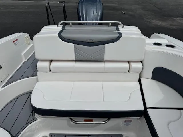 Slide: The Image of 2021 Chaparral 267 SSX OB boat seating area with white and gray upholstery. - 16