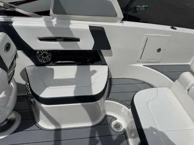 Slide: The Image of 2021 Chaparral 267 SSX OB boat interior with seating and speaker, featuring sleek design elements. - 18