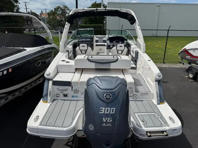 Slide: The Image of 2021 Chaparral 267 SSX OB boat with Yamaha 300 V6 engine, docked outdoors. - 2
