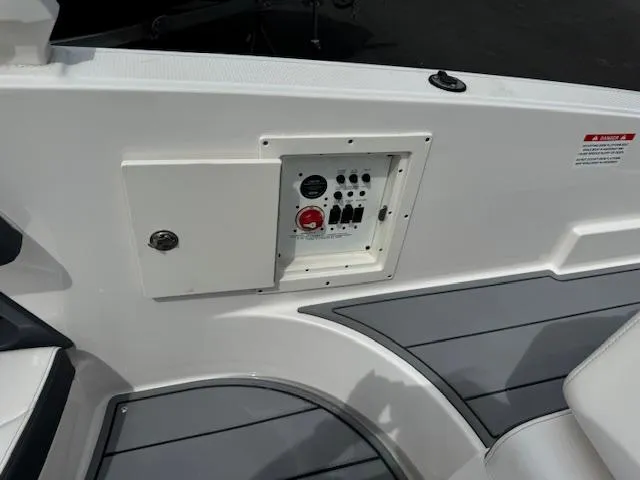 Slide: The Image of Control panel on 2021 Chaparral 267 SSX OB boat, featuring switches and a red button. - 20