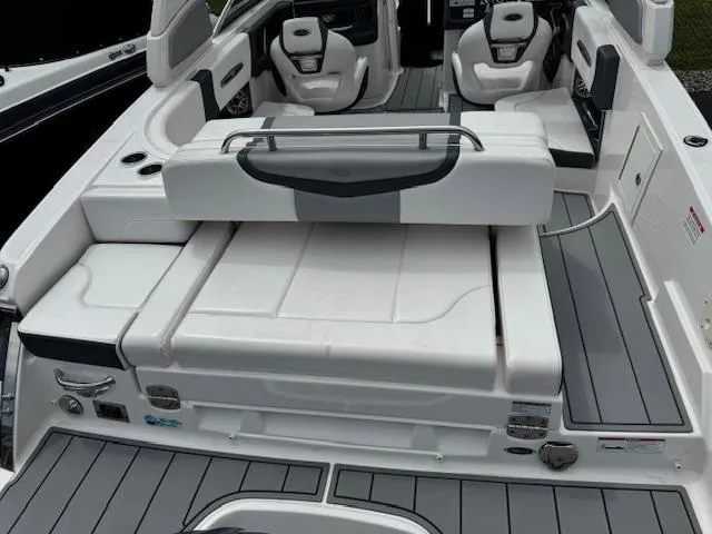 Slide: The Image of 2021 Chaparral 267 SSX OB boat interior with white seating and gray flooring. - 22