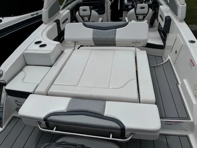 Slide: The Image of 2021 Chaparral 267 SSX OB boat interior with white seating and modern design. - 23