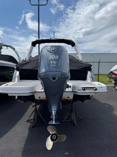 Slide: The Image of 2021 Chaparral 267 SSX OB boat with Yamaha 300 V6 outboard motor, parked outdoors. - 25