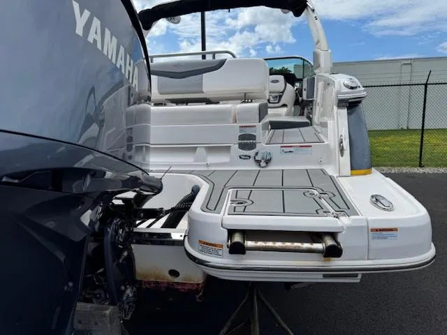 Slide: The Image of 2021 Chaparral 267 SSX OB boat with Yamaha outboard motor, featuring spacious deck and seating. - 26