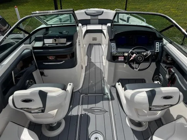 Slide: The Image of 2021 Chaparral 267 SSX OB boat interior with modern dashboard and seating. - 3