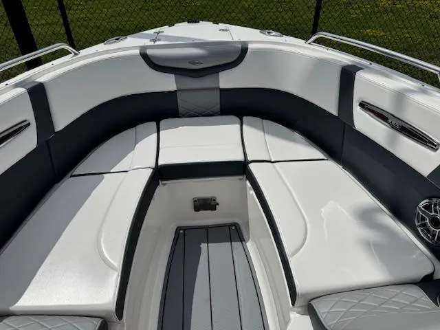 Slide: The Image of 2021 Chaparral 267 SSX OB boat interior with cushioned seating and sleek design. - 6