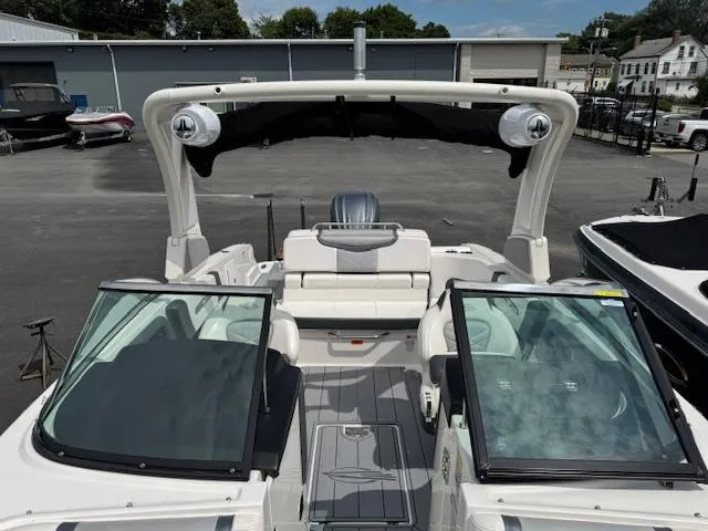 Slide: The Image of 2021 Chaparral 267 SSX OB boat with open cockpit and seating, displayed outdoors. - 8