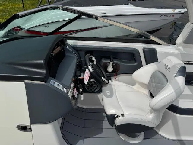 Slide: The Image of 2021 Chaparral 267 SSX OB boat cockpit with modern steering and seating. - 9