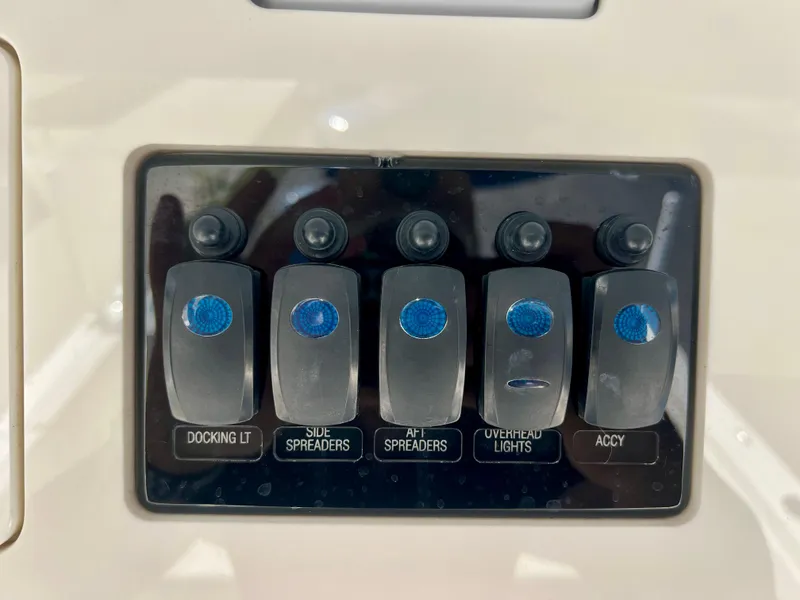 Slide: The Image of Control panel of 2023 Sailfish 272 CC boat with labeled switches for lighting. - 12