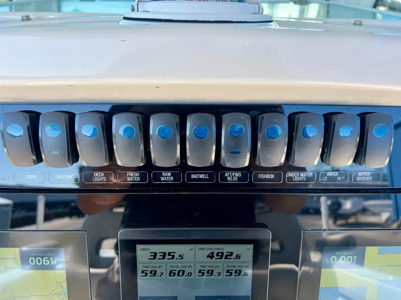 Slide: The Image of Control panel of 2023 Sailfish 272 CC boat with various switches and digital displays. - 13