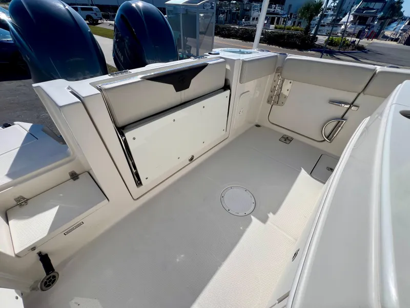 Slide: The Image of 2023 Sailfish 272 CC boat deck with storage compartments and seating area. - 15