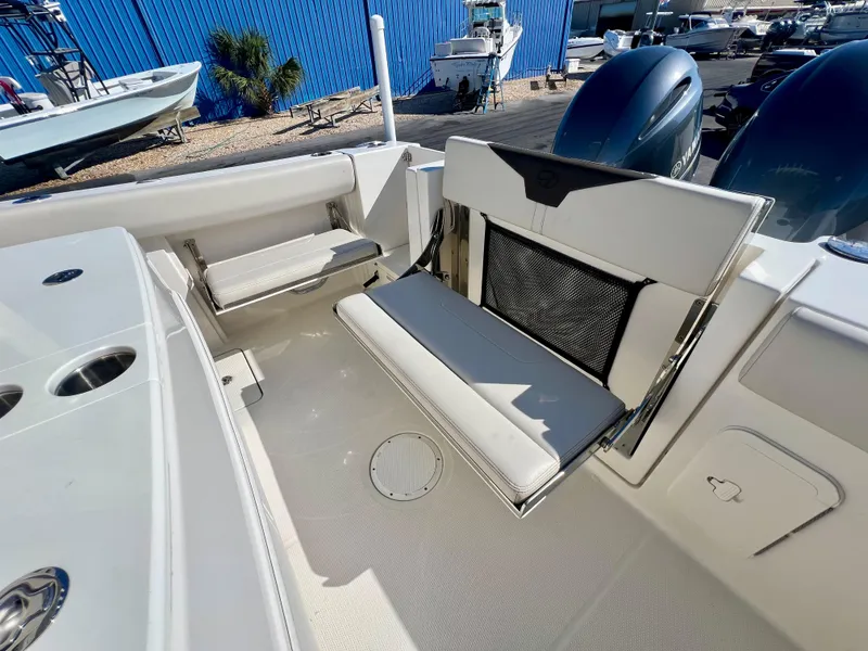 Slide: The Image of 2023 Sailfish 272 CC boat interior with foldable seating and dual engines. - 17