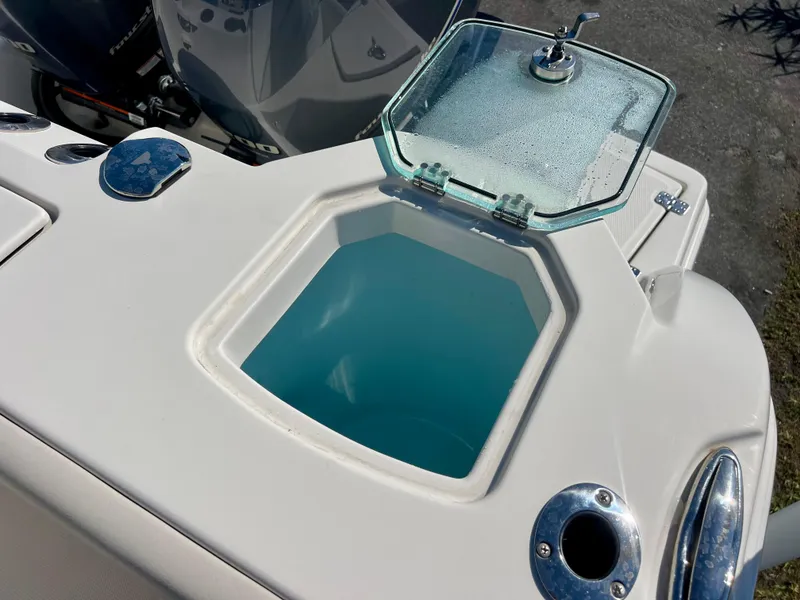 Slide: The Image of 2023 Sailfish 272 CC boat livewell with open lid, showcasing interior. - 19