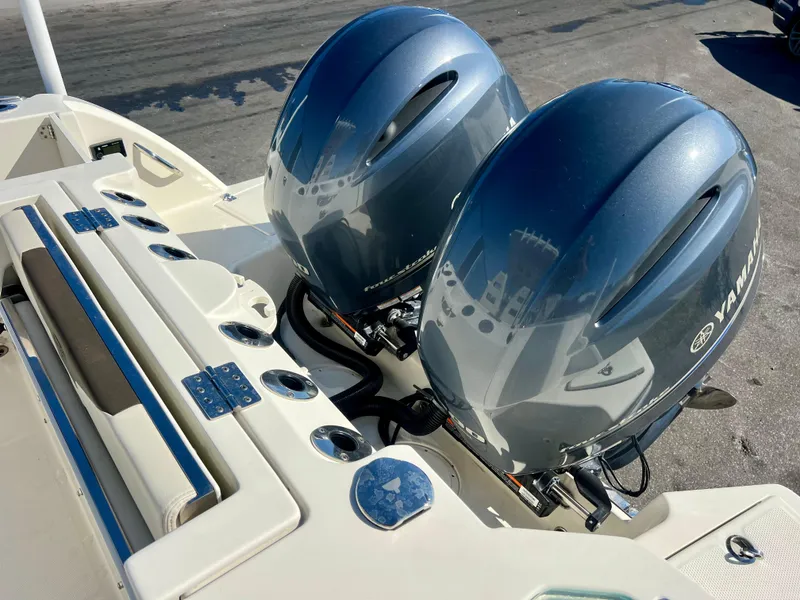 Slide: The Image of 2023 Sailfish 272 CC boat with dual Yamaha outboard engines, docked on a sunny day. - 20
