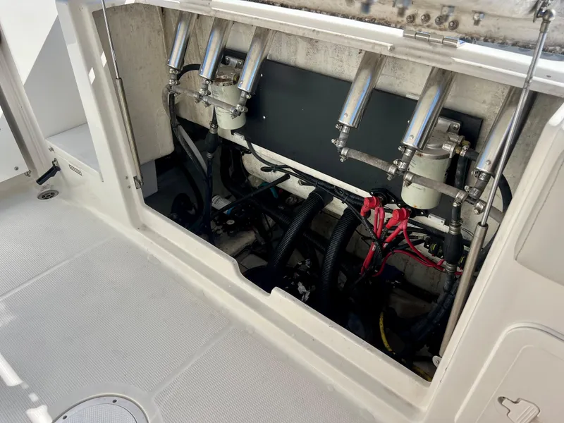 Slide: The Image of 2023 Sailfish 272 CC boat engine compartment with hydraulic systems and wiring. - 23