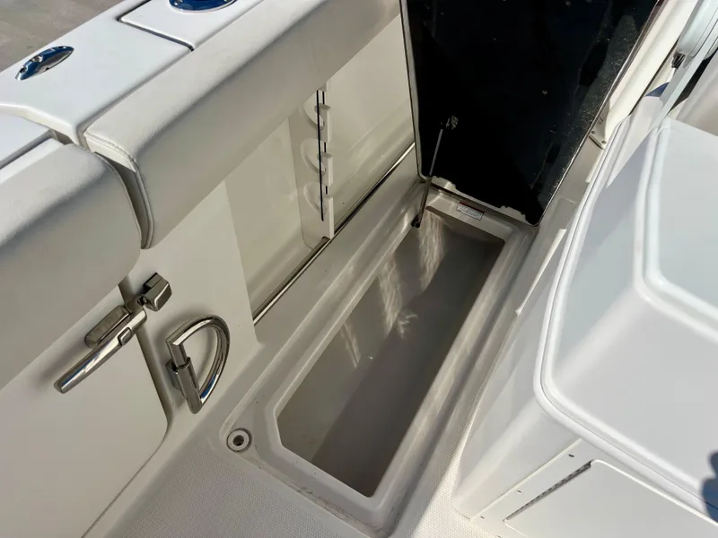 Slide: The Image of 2023 Sailfish 272 CC boat interior storage compartment with open hatch. - 24