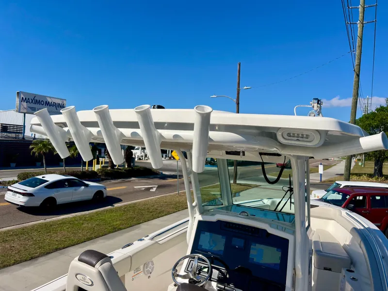 Slide: The Image of 2023 Sailfish 272 CC boat with rod holders and console, parked near Maximo Marina. - 26