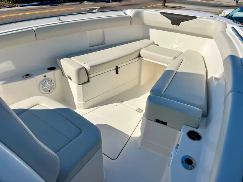 Slide: The Image of 2023 Sailfish 272 CC boat interior with cushioned seating and cup holders. - 27