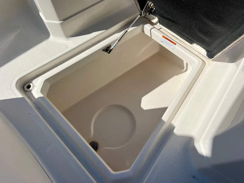 Slide: The Image of 2023 Sailfish 272 CC storage compartment with open lid, showcasing spacious interior design. - 29