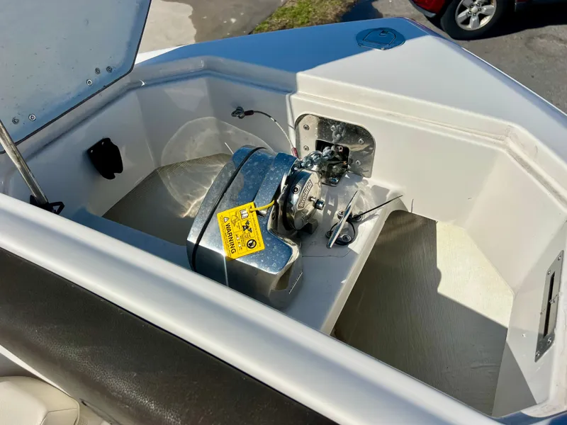 Slide: The Image of 2023 Sailfish 272 CC boat anchor compartment with winch and safety tag. - 30
