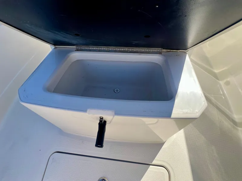 Slide: The Image of 2023 Sailfish 272 CC boat storage compartment with open lid, showcasing interior space. - 32