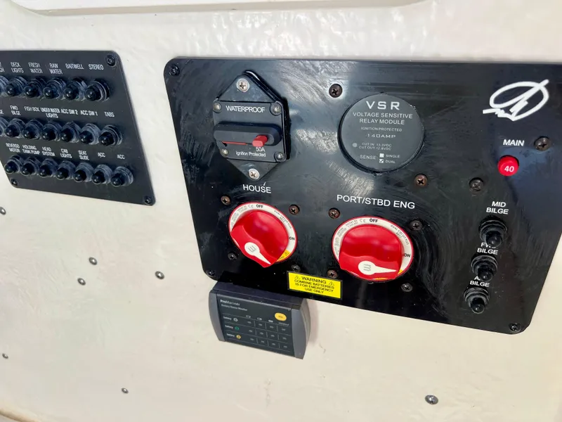 Slide: The Image of Control panel of 2023 Sailfish 272 CC boat with switches and dials. - 34