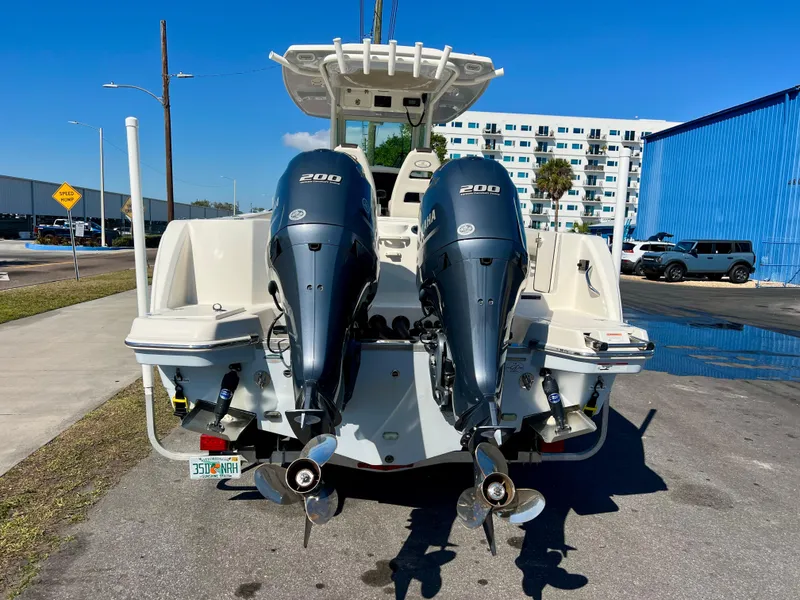 Slide: The Image of 2023 Sailfish 272 CC boat with dual 200 horsepower engines, parked outdoors. - 4