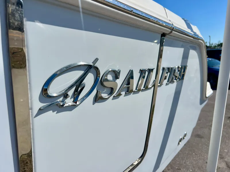 Slide: The Image of 2023 Sailfish 272 CC boat logo on white exterior in sunlight. - 5