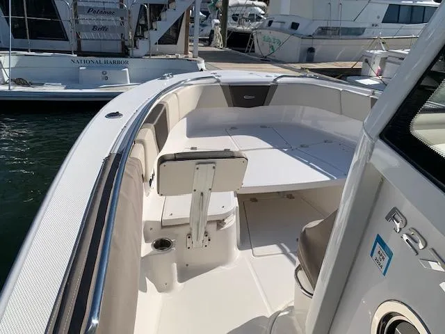 Slide: The Image of 2019 Robalo R272 Center Console boat interior at marina dock. - 12