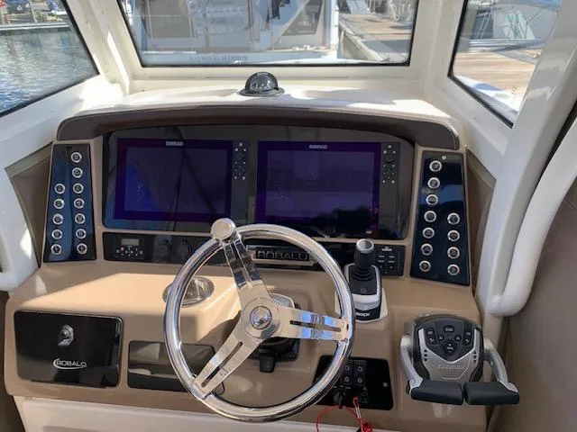 Slide: The Image of 2019 Robalo R272 Center Console helm with dual displays and steering wheel. - 16