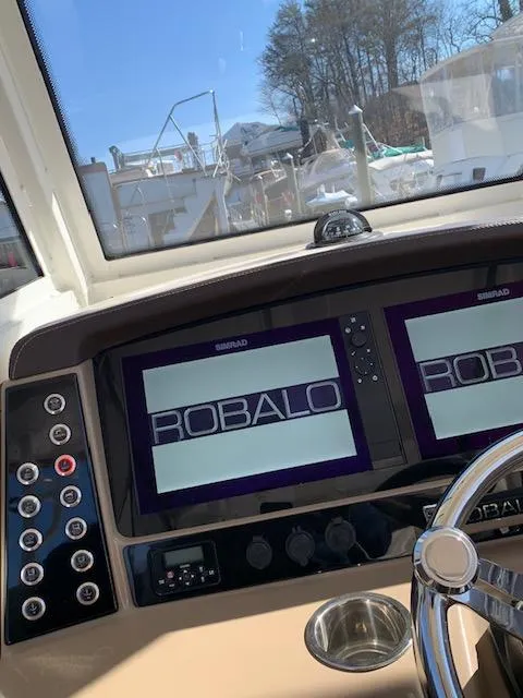 Slide: The Image of 2019 Robalo R272 Center Console boat dashboard with dual Simrad displays. - 17
