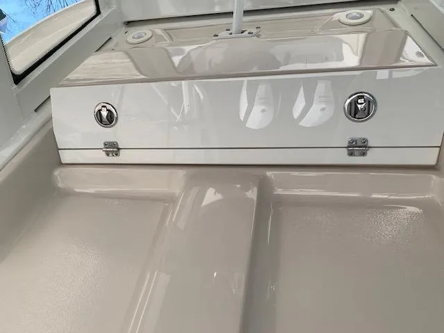 Slide: The Image of 2019 Robalo R272 Center Console boat interior with storage compartment. - 25