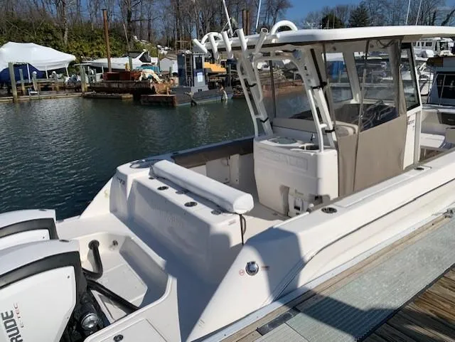 Slide: The Image of 2019 Robalo R272 Center Console boat docked at marina. - 3