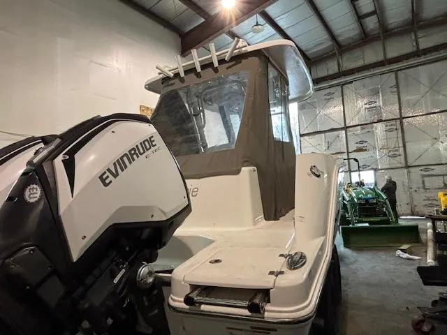 Slide: The Image of 2019 Robalo R272 Center Console boat with Evinrude engine in a warehouse. - 31
