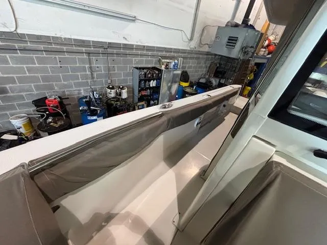 Slide: The Image of 2019 Robalo R272 Center Console boat in a garage with tools and equipment. - 33