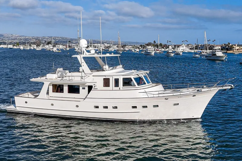 Slide: The Image of 2018 Fleming 58 Pilothouse yacht cruising in a scenic harbor. - 1