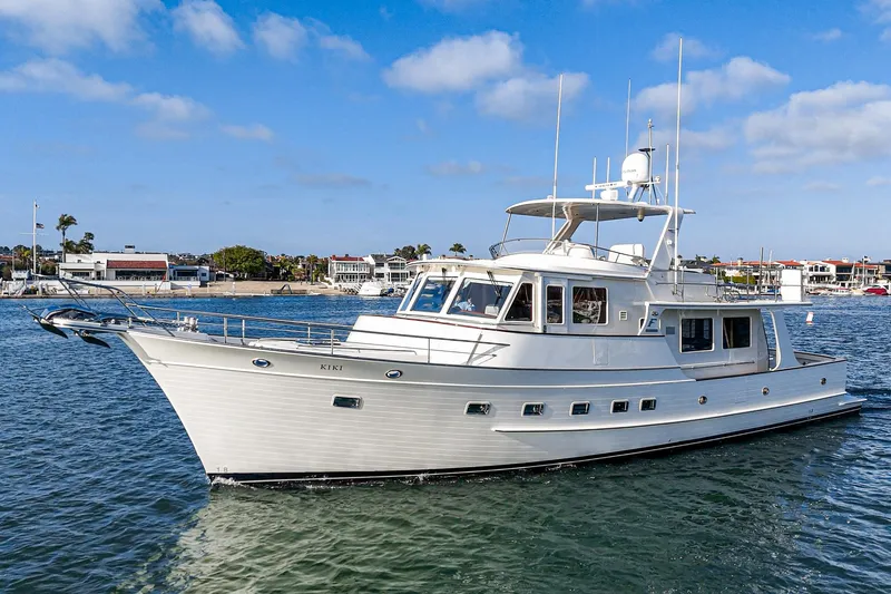 Slide: The Image of 2018 Fleming 58 Pilothouse yacht cruising in a sunny harbor. - 13