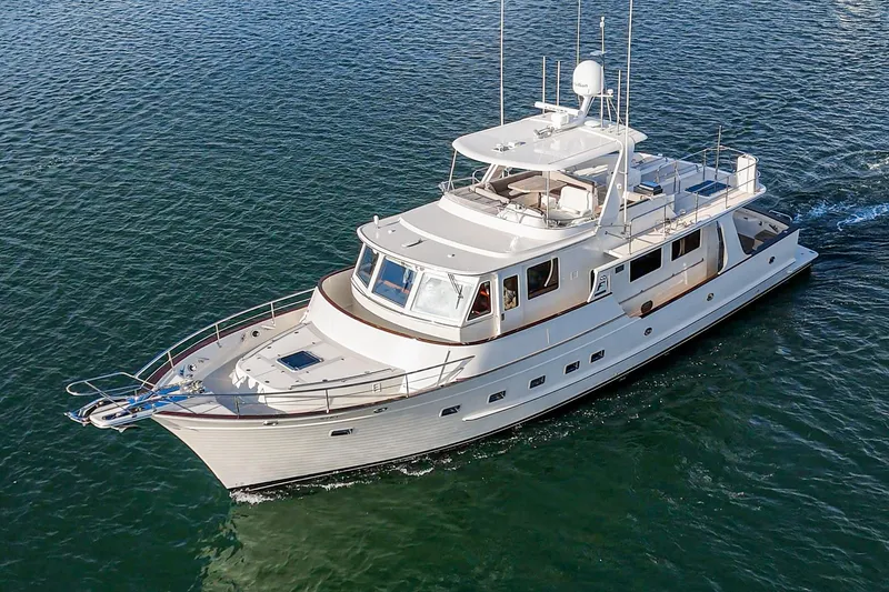 Slide: The Image of 2018 Fleming 58 Pilothouse yacht cruising on open water. - 14