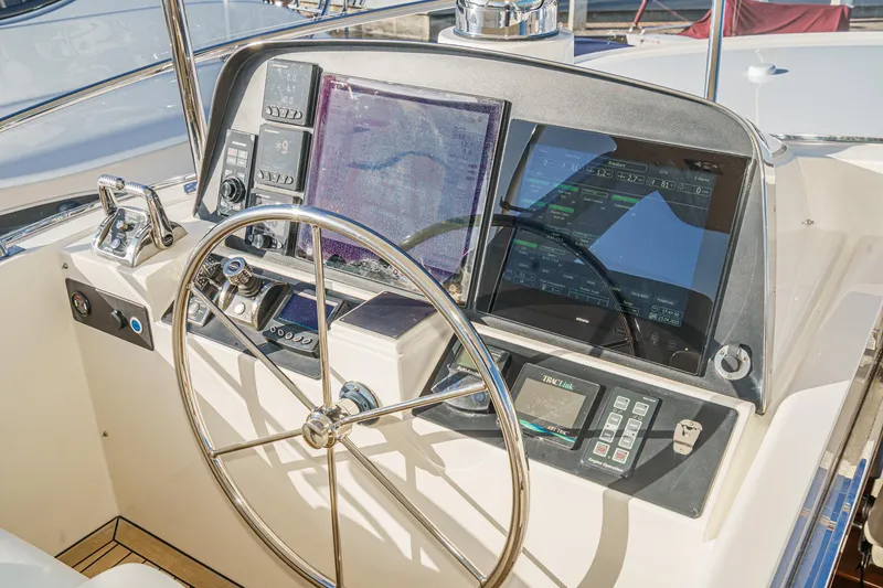Slide: The Image of 2018 Fleming 58 Pilothouse helm with advanced navigation displays and steering wheel. - 21