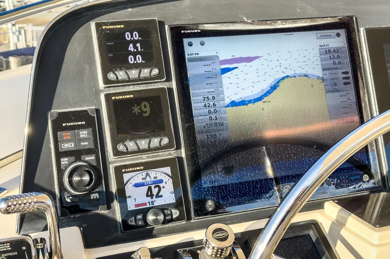 Slide: The Image of Control panel of a 2018 Fleming 58 Pilothouse with navigation displays and instruments. - 24