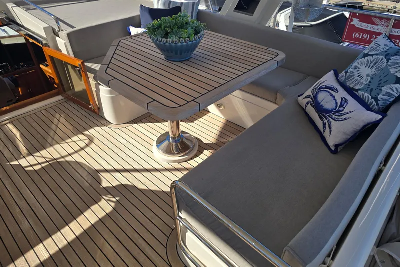 Slide: The Image of Luxurious 2018 Fleming 58 Pilothouse yacht deck with cushioned seating and decorative pillows. - 25