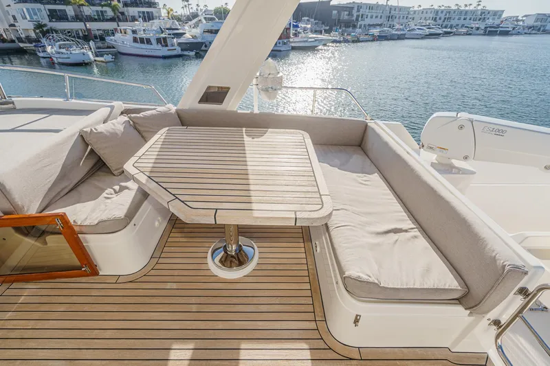 Slide: The Image of Luxurious seating area on 2018 Fleming 58 Pilothouse yacht with waterfront view. - 37